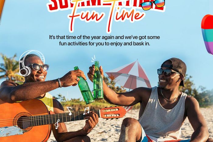 Two men sitting on a beach with drinks and a guitar.