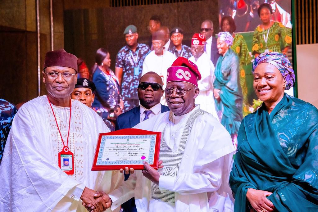 INEC chairman, Prof Mahmood Yakubu, presents certificate of return to president-elect, Bola Tinubu [Twitter/@BashirAhmaad]