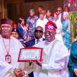 INEC chairman, Prof Mahmood Yakubu, presents certificate of return to president-elect, Bola Tinubu [Twitter/@BashirAhmaad]