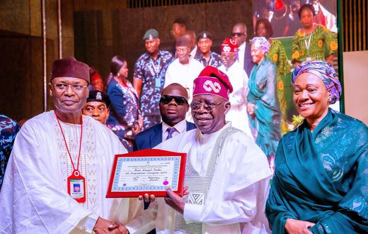 INEC chairman, Prof Mahmood Yakubu, presents certificate of return to president-elect, Bola Tinubu [Twitter/@BashirAhmaad]