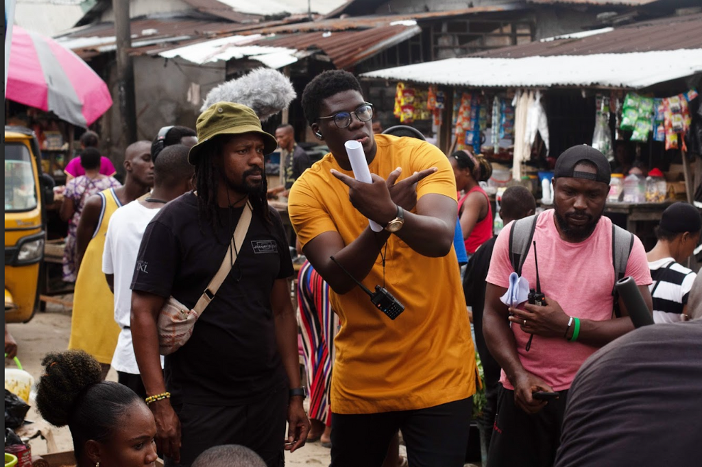 Stills of the director (Courage Obayuwana in yellow top) on the set of Kill Boro.