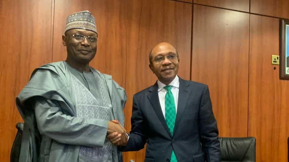 Chairman of the Independent National Electoral Commission, Mahmood Yakubu and Godwin Emefiele, the Governor of the Central Bank of Nigeria. (Tribune)