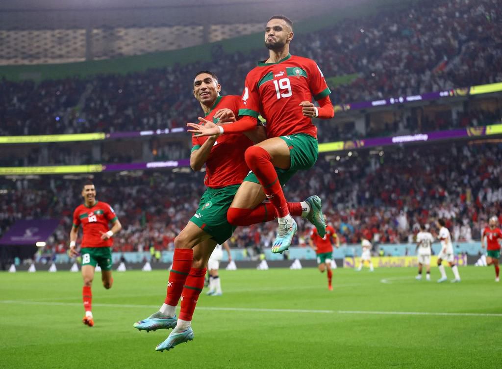 Achraf Hakimi (L) celebrates with Youssef En Neysri after his goal against Portugal