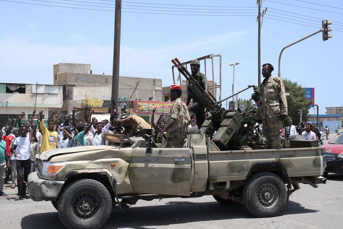 Sudanese greet army soldiers, loyal to army chief Abdel Fattah al-Burhan, in the Red Sea city of Port Sudan on April 16, 2023.AFP via Getty Images