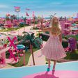 Margot Robbie's Barbie waving to Barbie Land citizens in "Barbie."Warner Bros. Pictures