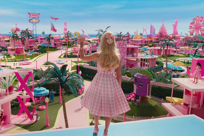 Margot Robbie's Barbie waving to Barbie Land citizens in "Barbie."Warner Bros. Pictures