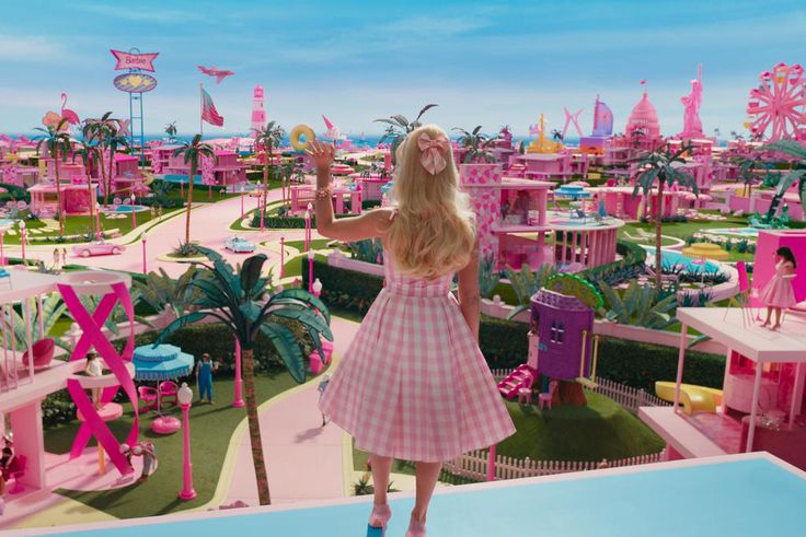 Margot Robbie's Barbie waving to Barbie Land citizens in "Barbie."Warner Bros. Pictures