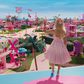 Margot Robbie's Barbie waving to Barbie Land citizens in "Barbie."Warner Bros. Pictures