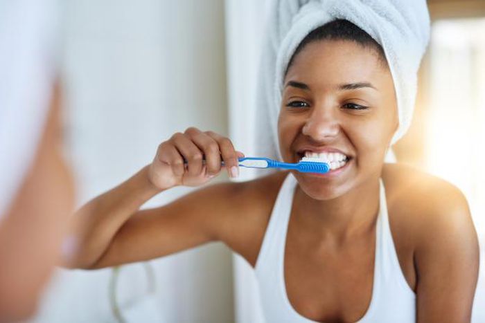 A lady brushing [Yahoo Life UK]