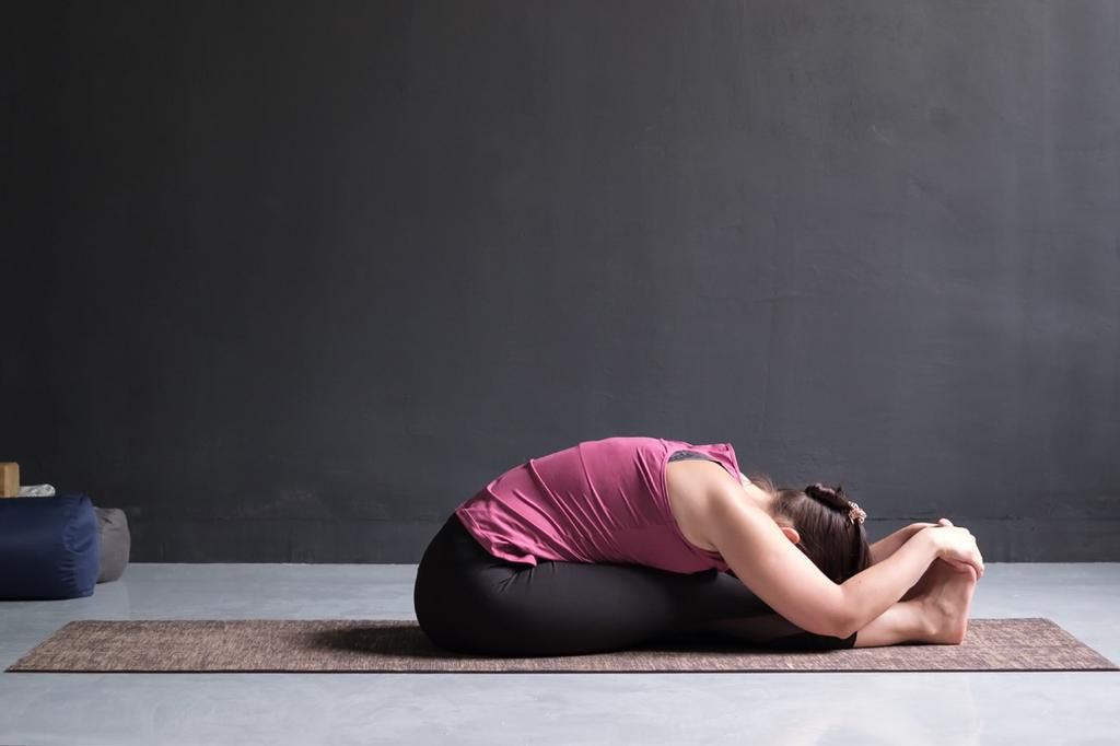 The seated-forward-bend-pose eases cramps [FitsriYoga]