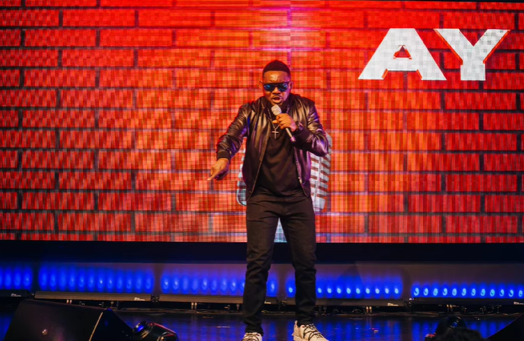 Ayodeji "AY" Makun during the performance of AY: Spotting the Difference [Instagram/@aycomedian]