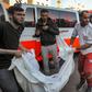 The body of a victim killed in an Israeli bombardment is taken out of an ambulance in Gaza City.DAWOOD NEMER/AFP via Getty Images