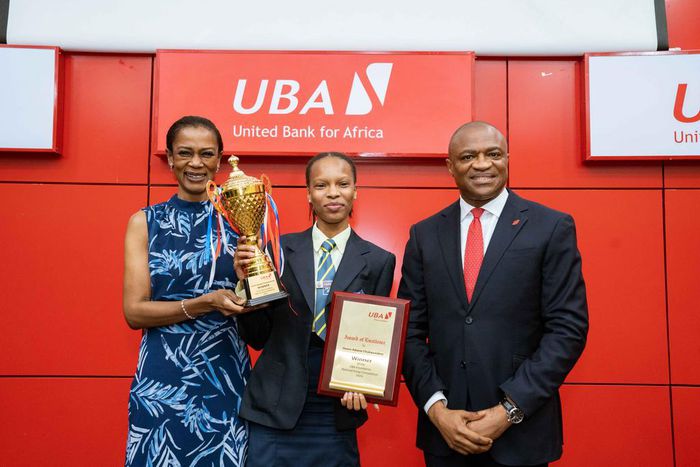 L-R: Managing Director/CEO , United Bank for Africa(UBA) Foundation, Mrs Bola Atta; winner, 2023 UBA National Essay Competition and Student of Fountain Heights Secondary School, Adaeze Onaro and  Group Managing Director/CEO, UBA Plc, Mr. Oliver Alawuba