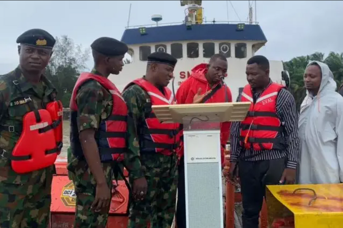 Picture showing the Commanding Officer handing over MV TIS IV vessel in Brass. [NAN]