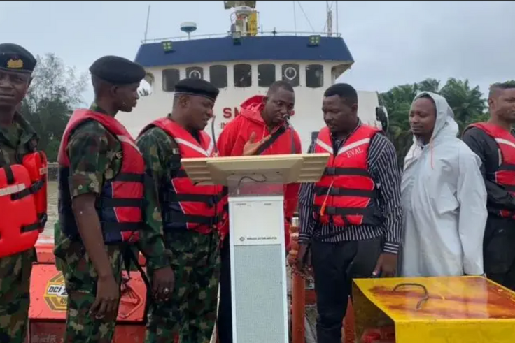 Picture showing the Commanding Officer handing over MV TIS IV vessel in Brass. [NAN]