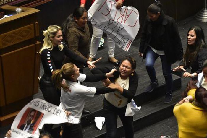 Pro-government MPs attempted to seize placards held by opposition members bearing messages such as "With political prisoners, there is no democracy" [Sun News]