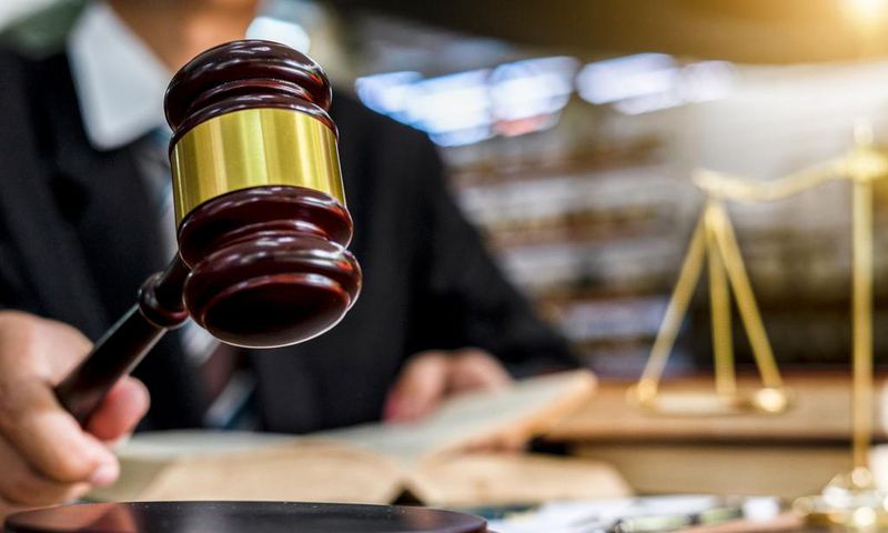 A judge uses a gavel in a courtroom.Naruecha Jenthaisong/Getty Images