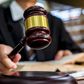 A judge uses a gavel in a courtroom.Naruecha Jenthaisong/Getty Images