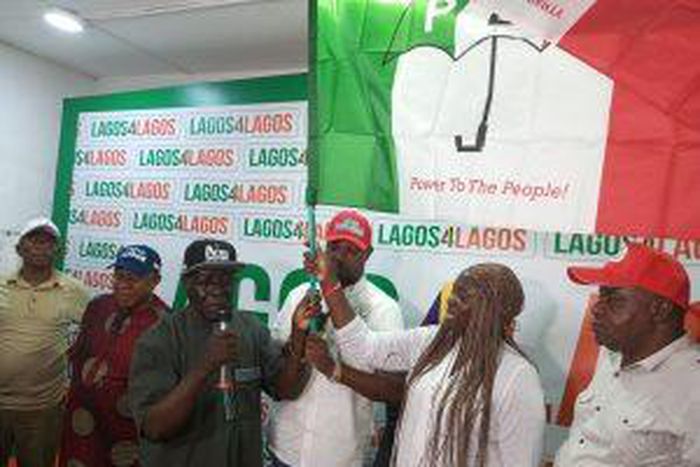 PDP Chairman, Mr Philips Aivoji, handling over the party’s flag to the leader of the defectors, Miss Dabiraoluwa Adeyinka on Monday in Lagos.