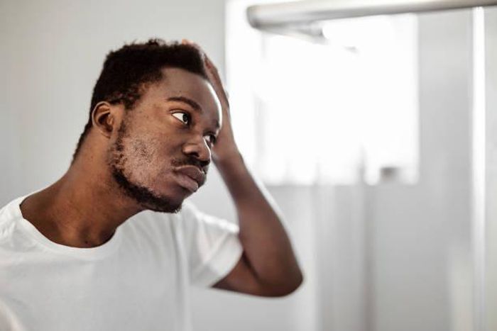 A man looking at himself in the mirror