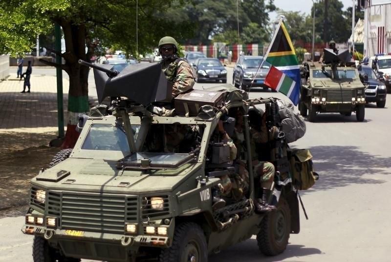 Military vehicles lead the way as South African President Jacob Zuma arrives as the head of an Africa Union-lead delegation in an attempt to broker dialogue to end months of violence in Burundi's capital Bujumbura February 25, 2016. REUTERS/Evrard Ngen...