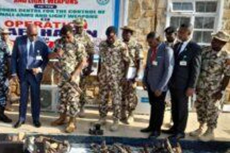 OPSH Commander, Maj.-Gen. Abdusalam Abubakar, handing over recovered illegal weapons to Maj.-Gen. Hamza Bature, the North-Central Coordinator of NCCSALW in Jos. (Credit: NAN)