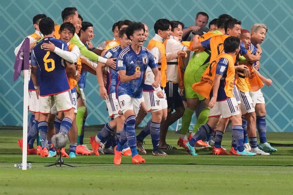 The Japan national team players celebrating an unlikely victory over Germany