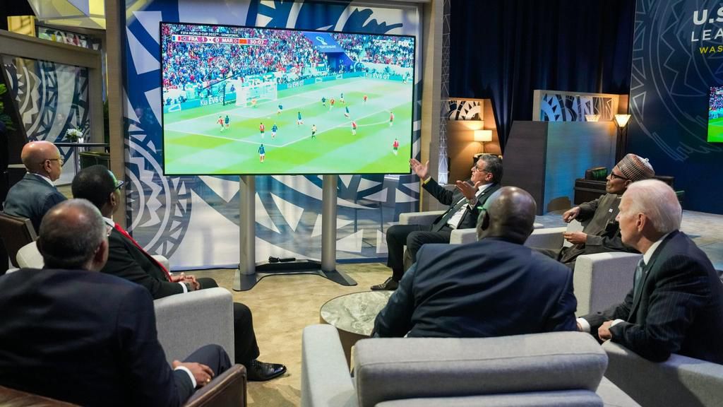 Nigerians react as Buhari watches the World Cup semifinal with U.S. President Joe Biden.