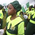 female student holding the nigerian flag at past indepence day celebration