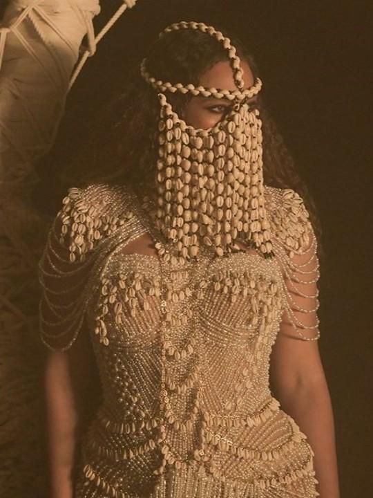 Beyonce wearing a cowrie head piece