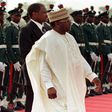 Former Nigerian President General Sani Abacha walks past a line of military troops March 23 during the departure ceremony for Pope John Paul II who was ending a three day visit to the country. NIGERIA POPE (Reuters)