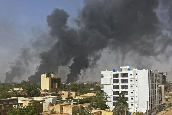 Smoke billows above residential buildings in Khartoum on as fighting in Sudan raged for a second day on April 16.Source: AFP/Getty Images.