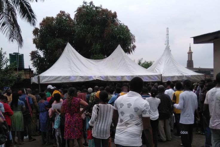 Nigerians queue at the Independent National Electoral Commission (INEC) office in Surulere, Lagos State to collect their permanent voters' cards (PVC)