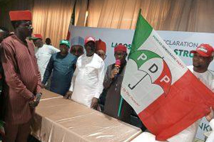 Gov. Ifeanyi Okowa, PDP Vice Presidential Candidate handling over party’s flag to the ADC defectors in Lagos on Sunday