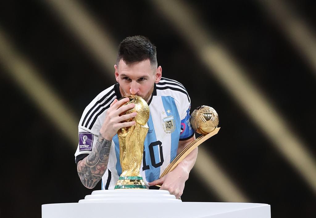 Lionel Messi with the World Cup trophy and his golden ball after leading Argentina to victory against France in the final in Qatar