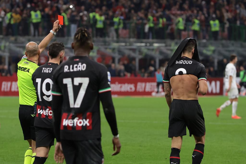 A disappointed Giroud walks after he was sent off.