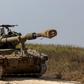 Israeli soldiers ride atop an artillery unit near the Israeli side of the border between Israel and the Gaza Strip, November 3, 2023.REUTERS/Amir Cohen