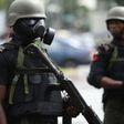 A Nigerian police officer wearing a gas mask