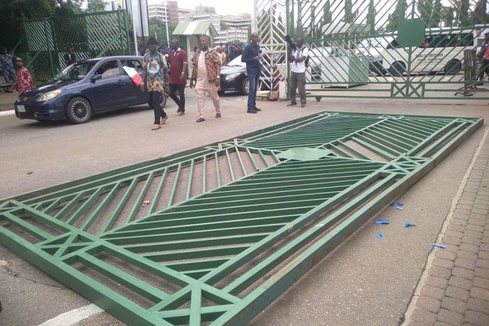The National Assembly gate pulled down by protesters. [Punch]