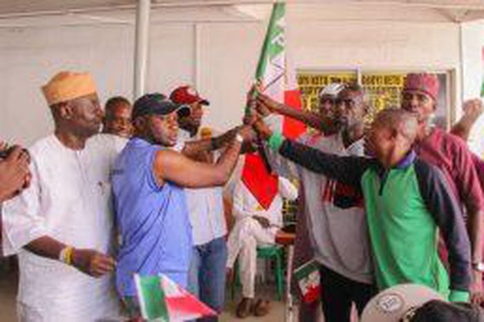 Leaders of the APC defectors to PDP receiving party’s flags at Liberty House, Ikeja on Tuesday.