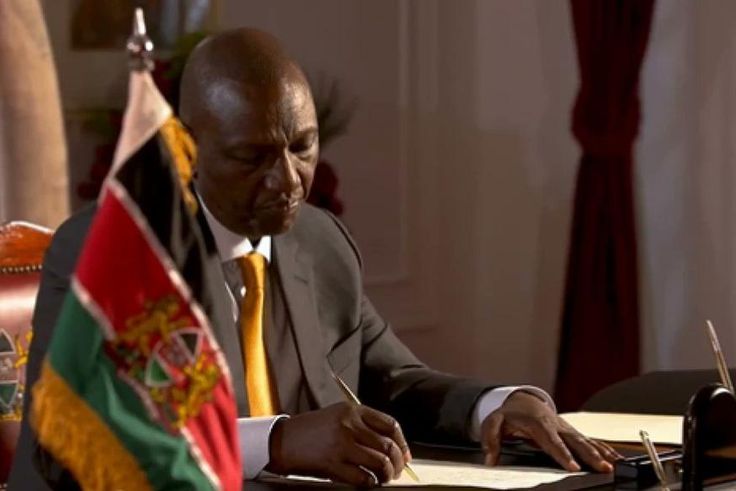 President William Ruto signs a document at State House