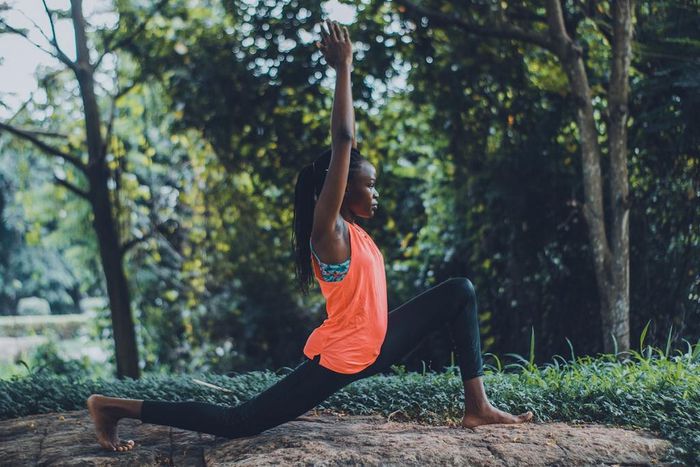 A woman showcasing a yoga pose outdoors [Photo: Oluremi Adebayo]