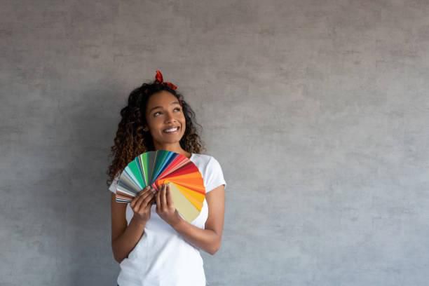 Woman thinking about the right colour to paint her house