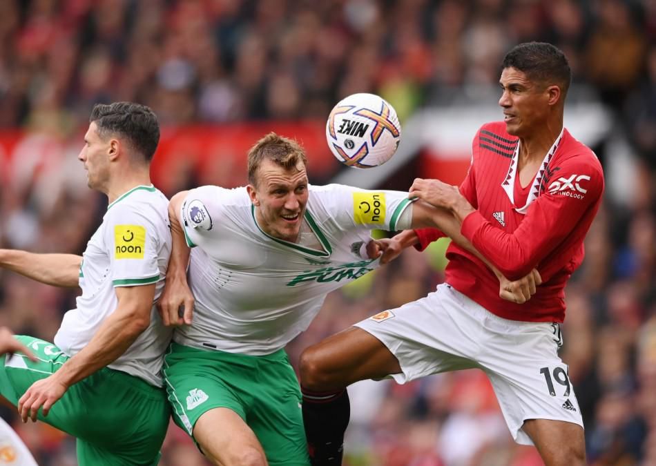 Raphael Varane of Manchester United contests with Newcastle defender Dan Burn