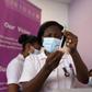 A health worker holds up the AstraZeneca vaccine at the Ridge Hospital in Accra, Ghana, on March 2, 2021.