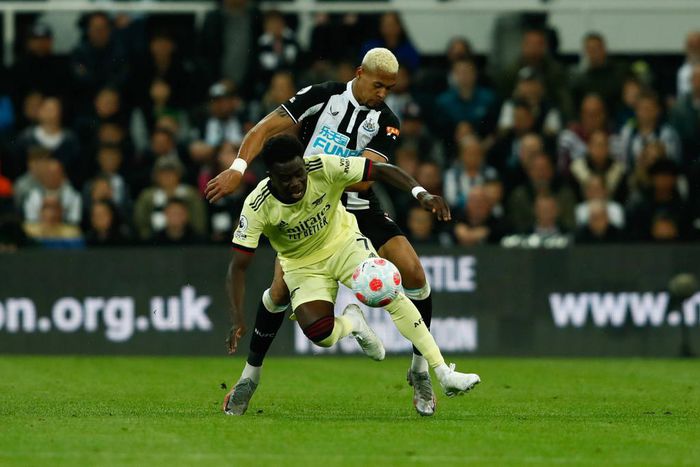 Newcastle United v Arsenal - Premier League Joelinton of Newcastle United and Bukayo Saka of Arsenal in action during the Premier League match between Newcastle United and Arsenal at St. James s Park