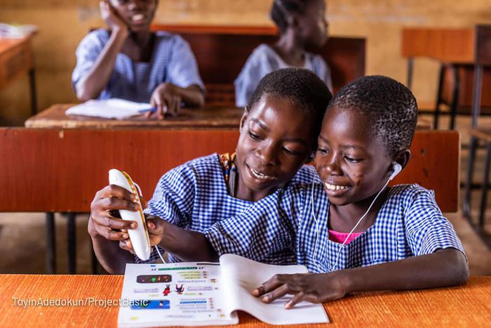 Pupils of St. Peters Anglican Primary School, Joga Orile in Ogun State interacting with talking book and pen.