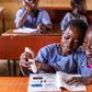 Pupils of St. Peters Anglican Primary School, Joga Orile in Ogun State interacting with talking book and pen.