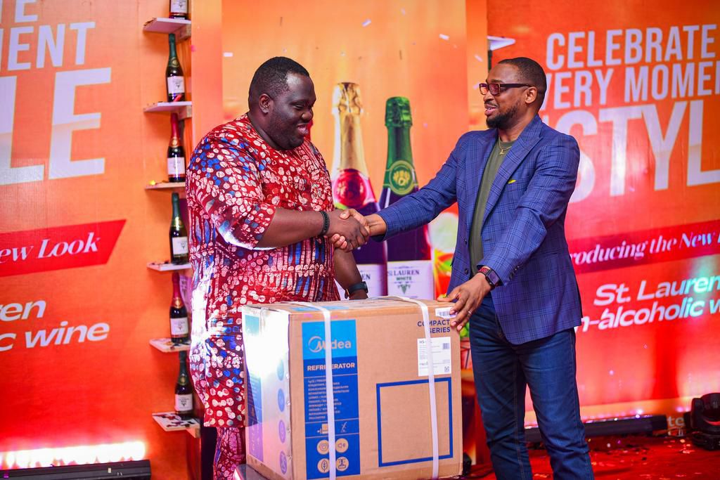 L-R: Stanley Obi, Director, Prime Business Unit, Grand Oak Limited, presenting a gift to the winner of the St. Lauren raffle draw at the relaunch of St. Lauren's new look at Lagos Sheraton Hotel