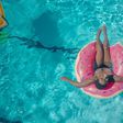 Woman on a pink swim ring [Photo: Kindel Media]